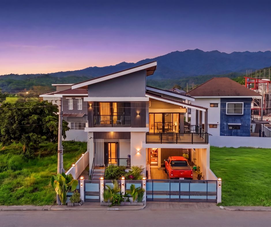Beach house exterior at twilight with mountain backdrop